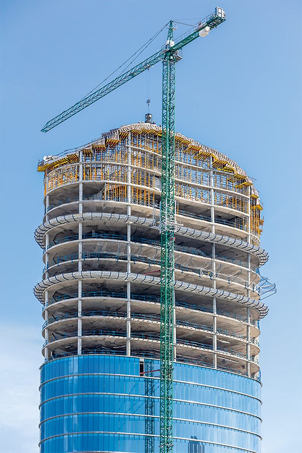 The ovate ground plan of the high-rise building develops into an elegantly curved roof landscape more than 100 m high.