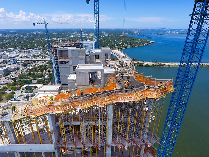 Tall shoring towers support a custom formwork solution to create a unique concrete ribbon structure on top of the building Tall shoring towers support a custom formwork solution to create a unique concrete ribbon structure on top of the building
