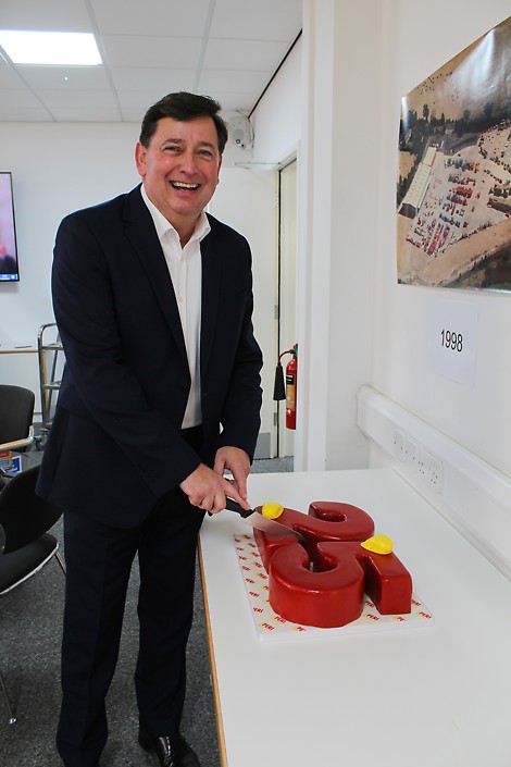 PERI UK Managing Director Ian Hayes cuts a celebratory cake to mark the occasion. PERI celebrates 25 years of Rugby headquarters