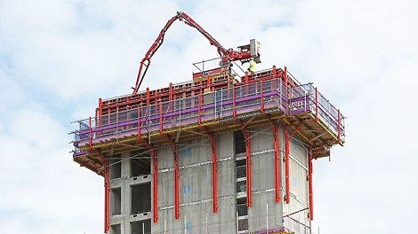 Bespoke Spider boom platform facilitates concrete placement on tower construction.