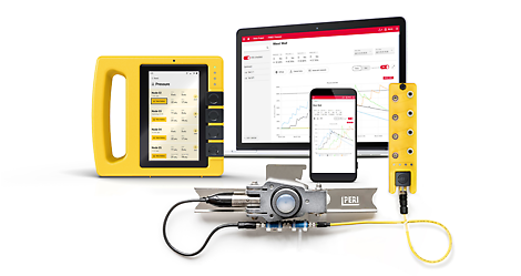 A computer screen showing reading from a concrete pressure sensor. A yellow handheld hub is connected to the sensor.