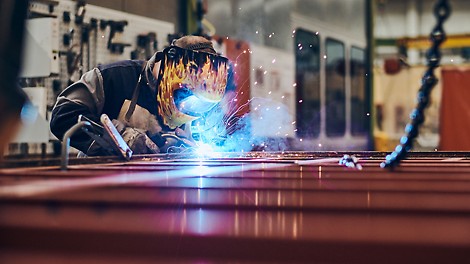 The picture shows a person working on a formwork panel.