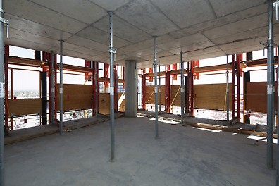 LPS Panels erected around the perimeter of the project shield crews and concrete from the wind while allowing light in.