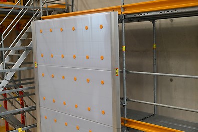 Protective scaffolding panels are attached to a scaffold.