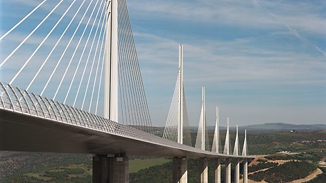 The Viaduc de Millau is a multispan clable-stayed bridge completed in 2004 across the gorge valley of the Tarn near Millau in the Averyron department in the Occitanie Region in Southern France. It is one of the largest cable stayed bridges in the world and a prime example of a infrastructure lighthouse being famous among professionals and laymen alike.