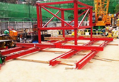 Initial assembly of single-lift platform on site. Note central platform opening for material transfer up and down the shaft. This central structure forms part of the "trussed" frame arrangement to transmit the imposed platform loads back to the 4 No. wall anchors. 