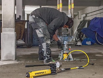 Mit nur einer Hydraulikeinheit ließen sich die PERI UP Schwerlaststützen vorspannen und – nach Erreichen der vollen Tragfähigkeit aller instand gesetzten Stahlbetonstützen – kontrolliert unter Last wieder absenken.