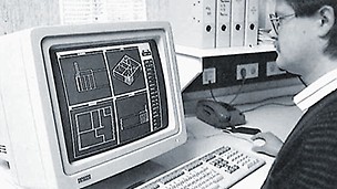 Worker in fornt of a personal computer working on a CAD drawing