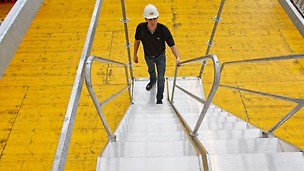 Treppenläufe können durch das Rastermaß von 25 cm auch nebeneinander eingebaut und die Laufrichtungen nach oben bzw. nach unten durch auf die Wangen aufgesteckte Geländer getrennt werden.