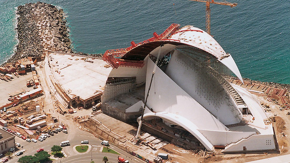 Auditorio de Tenerife, Tenerife, Spain - Due to the slender form of the building, the use of concrete for the realization of the structure was inevitable. A wide range of formwork expertise was required in order to complete this concert hall: from the use of the simple TRIO panel formwork for the foundations, climbing formwork for symmetrically-arranged round and curved sail-like walls, through to a very unusual special construction on the basis of the ACS self-climbing technology for the approx. 100 m long self-supporting roof assembly.