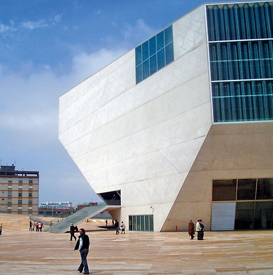 Casa da Música, Porto, Portugal - The architectural concrete building resembles a crystal whose shape develops from the inside out with the concert hall itself forming the heart of the structure. The concrete shell encloses a stack of room cubes and stretches around these as well as the intermediate spaces like a skin. (Photo: A. Minson, The Concrete Centre)