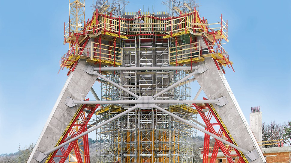 Units made of elements from the VARIOKIT modular system support the reverse-inclined formwork elements for the inclined legs of a 200 m high TV tower.