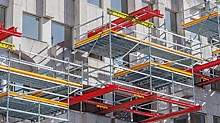 Work platforms can be integrated into existing structures by combining VARIOKIT and the PERI UP Scaffolding Kit.