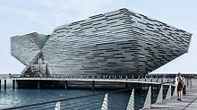 Japanese architect, Kengo Kuma, designed the two angular, funnel-shaped structures. One corner rises like the bow of a ship above the Firth of Tay in Craig Harbour.