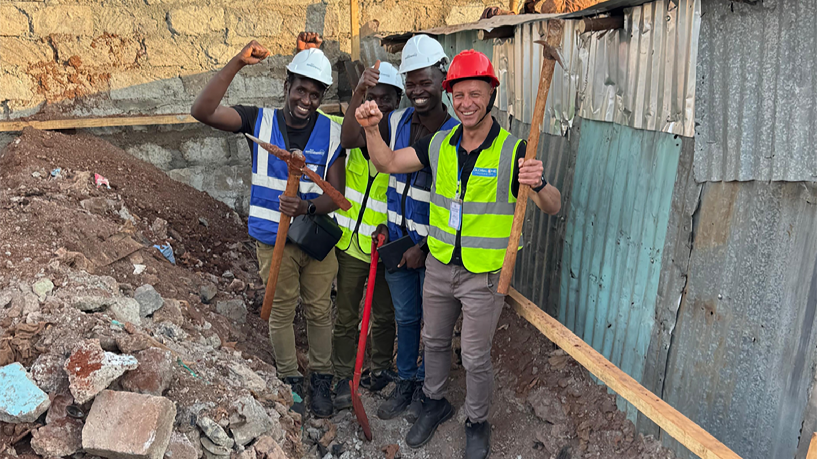 Justin Vero (right) of the Global One Foundation at the groundbreaking ceremony with the local construction team. 