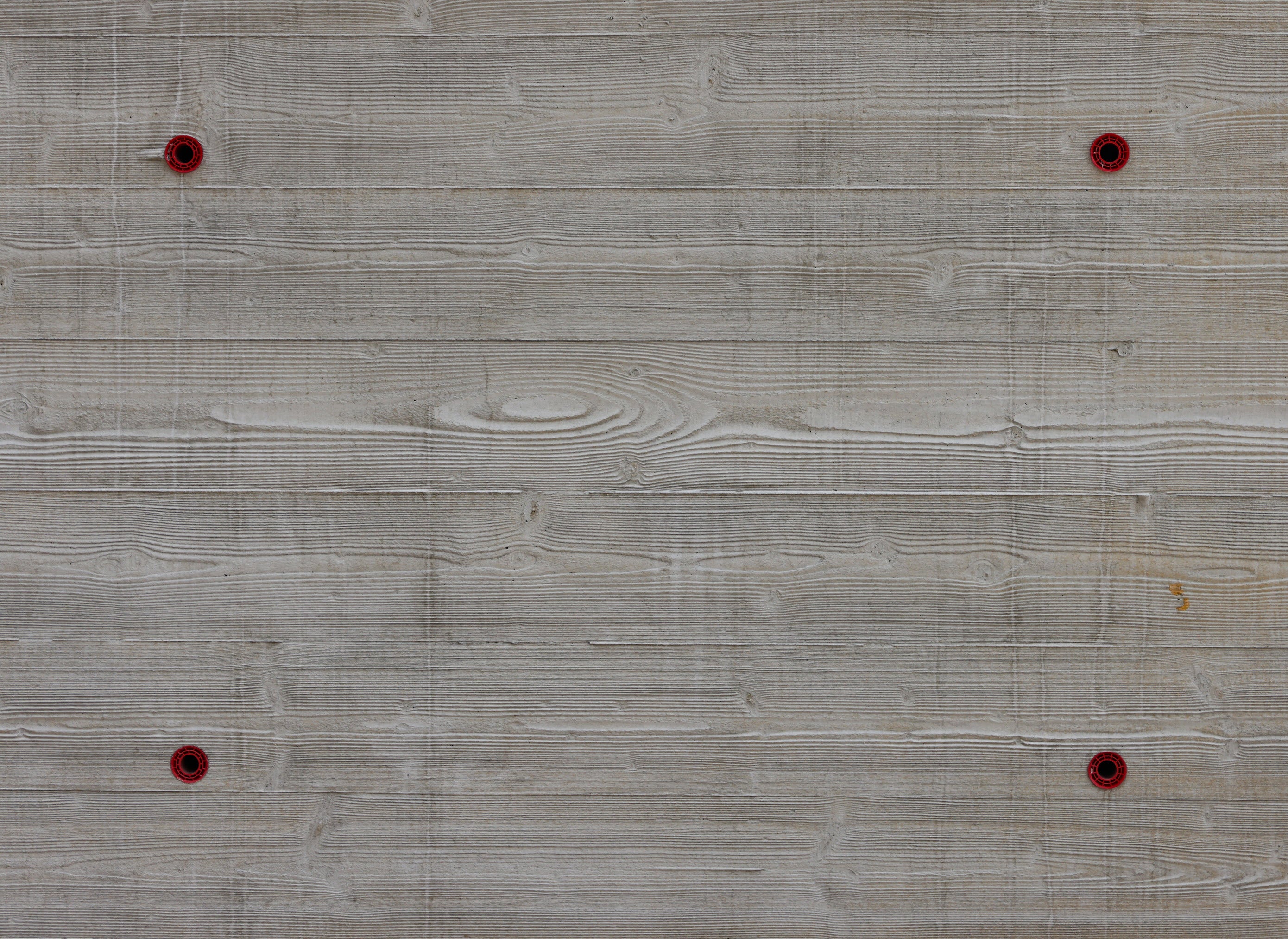 Board finish concrete pattern with symmetrical tie holes for exposed architectural concrete finish in building construction 