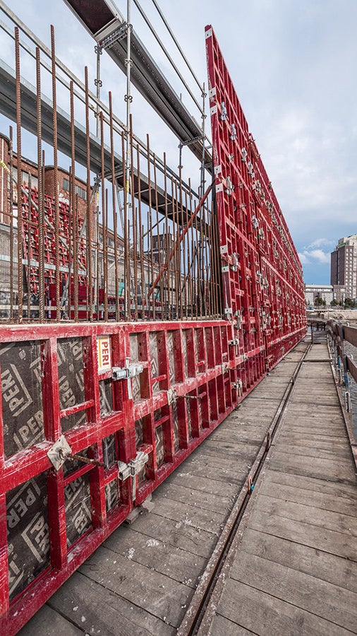 Für die Herstellung der Stützwand wurde die Sohlschalung einfach mit drei zusätzlichen, liegenden MAXIMO Elementen aufgestockt. Auf der Gegenseite diente ein PERI UP Bewehrungsgerüst als Arbeitsgerüst zum Bewehren sowie Schließen der Schalung.