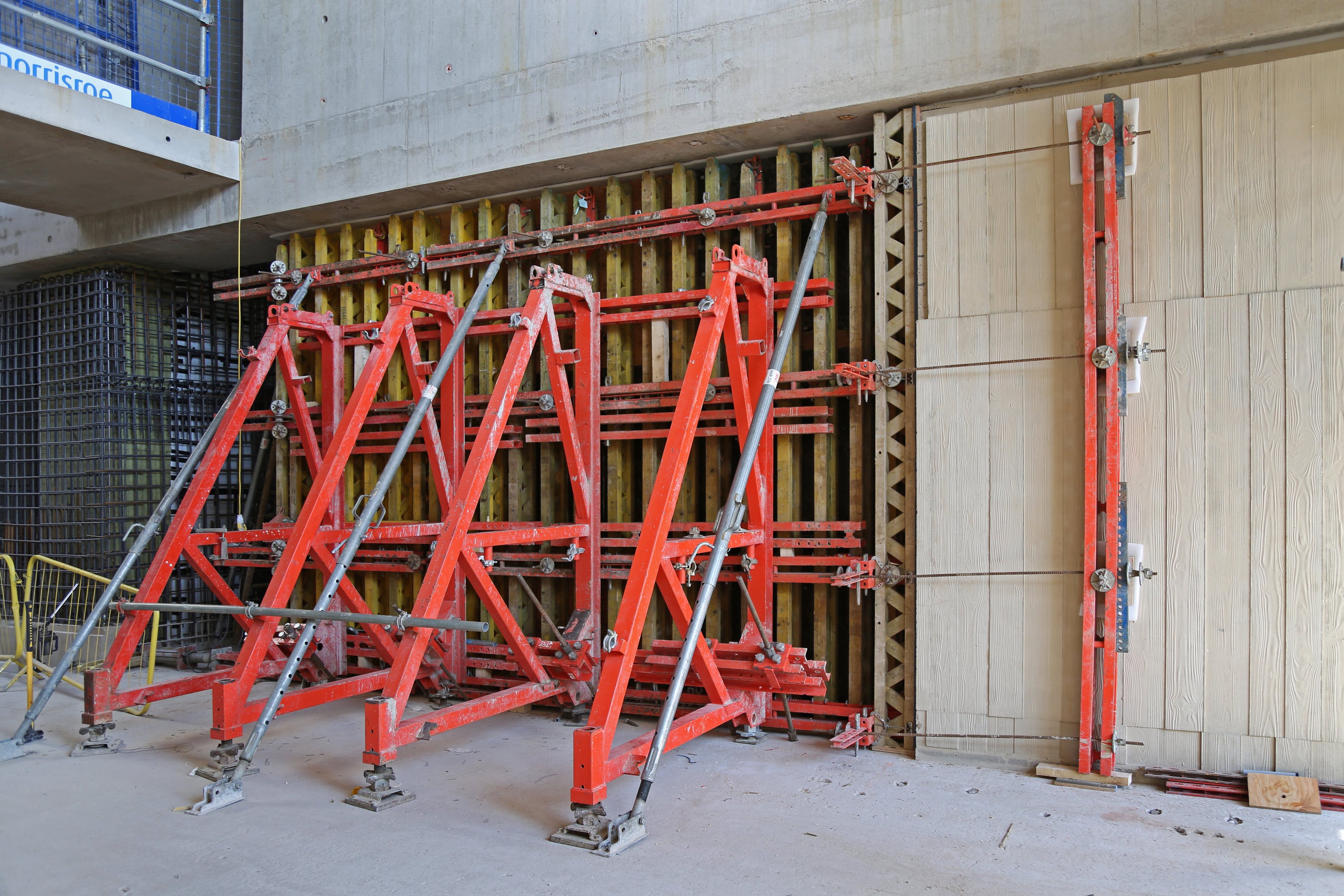 Board pattern architectural finish for concrete wall using PERI VARIO and SB single-sided brace frames to produce an exposed concrete finish for cultural building 