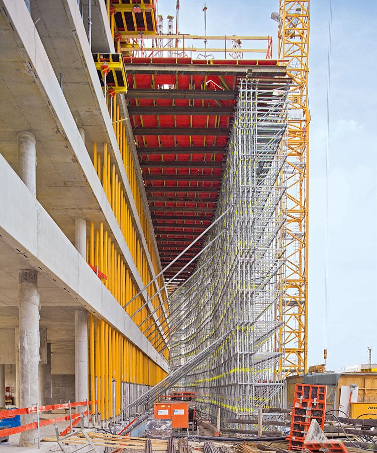 Das 93 m hohe Hochhaus kragt in Richtung der Bahnlinie um 7 m aus. Über eine Länge von 50 m dient ein 18 m hohes PERI UP Traggerüst zur Abfangung der Lasten.