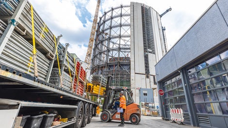 A new, circular building with 15 floors was constructed inside the steel structure.