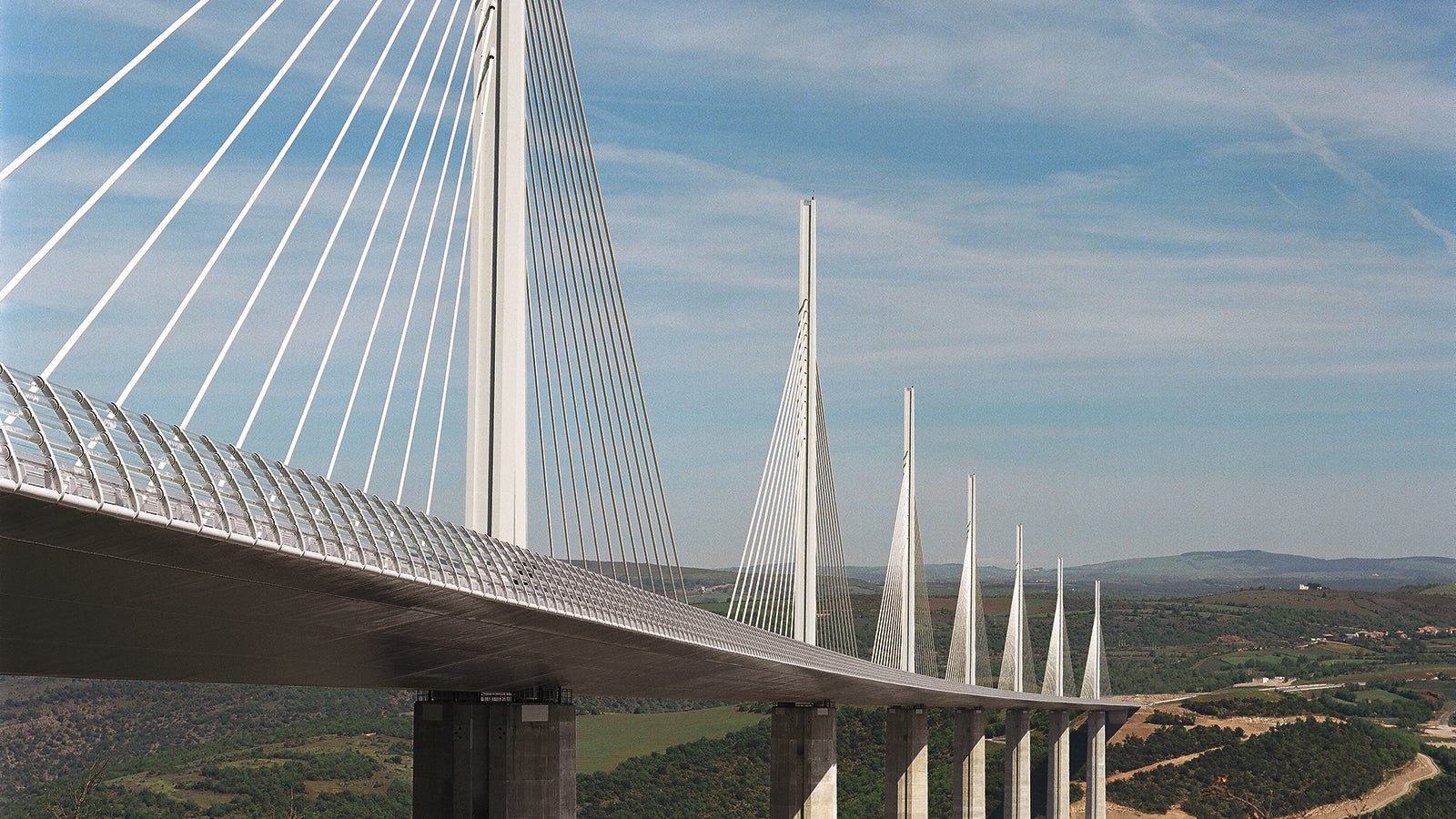The Viaduc de Millau is a multispan clable-stayed bridge completed in 2004 across the gorge valley of the Tarn near Millau in the Averyron department in the Occitanie Region in Southern France. It is one of the largest cable stayed bridges in the world and a prime example of a infrastructure lighthouse being famous among professionals and laymen alike.