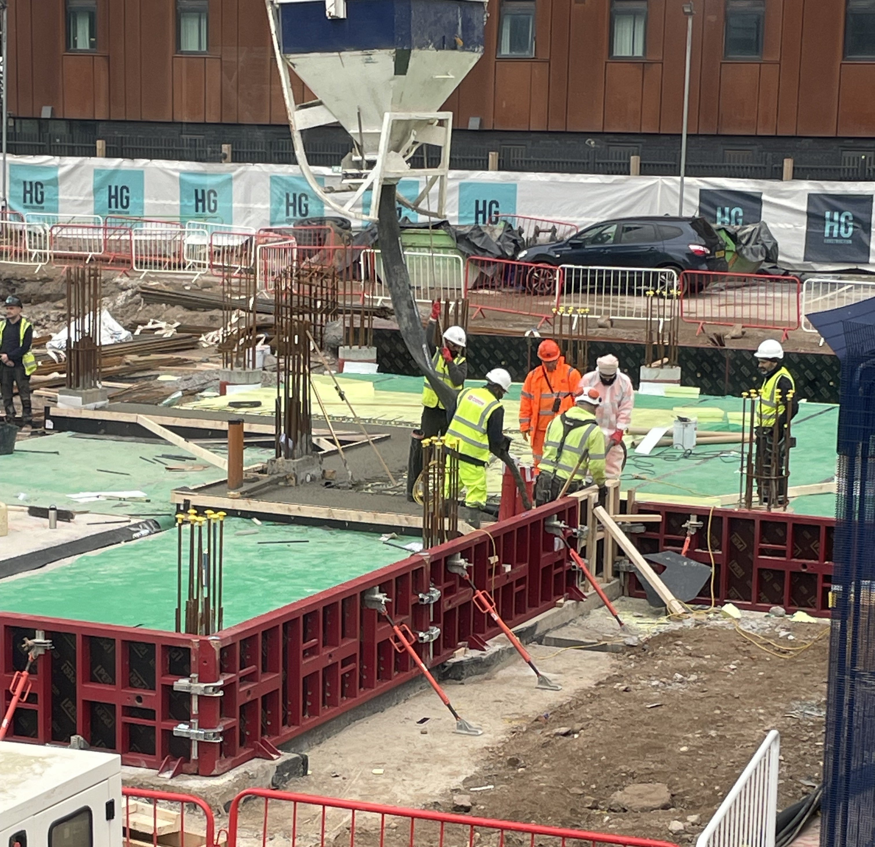 Contractors installing integrated waterproofing and formwork systems during early-stage construction, improving efficiency and reducing project delays.