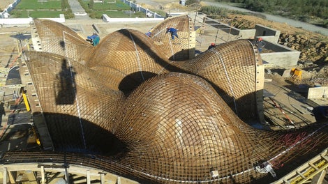 the intricate roof design was shaped through using customized girder trusses