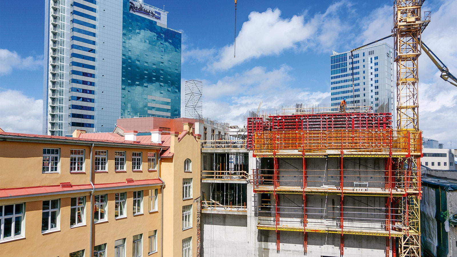 Three new buildings are seamlessly integrated into the existing architectural monuments and other more modern high-rise towers.
