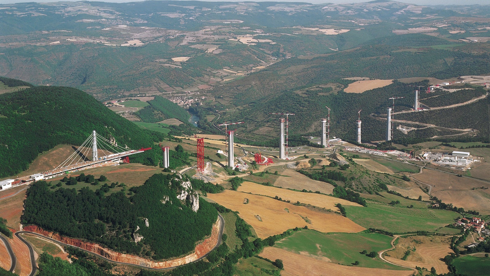 The Viaduc de Millau is a multispan clable-stayed bridge completed in 2004 across the gorge valley of the Tarn near Millau in the Averyron department in the Occitanie Region in Southern France. It is one of the largest cable stayed bridges in the world and a prime example of a infrastructure lighthouse being famous among professionals and laymen alike.