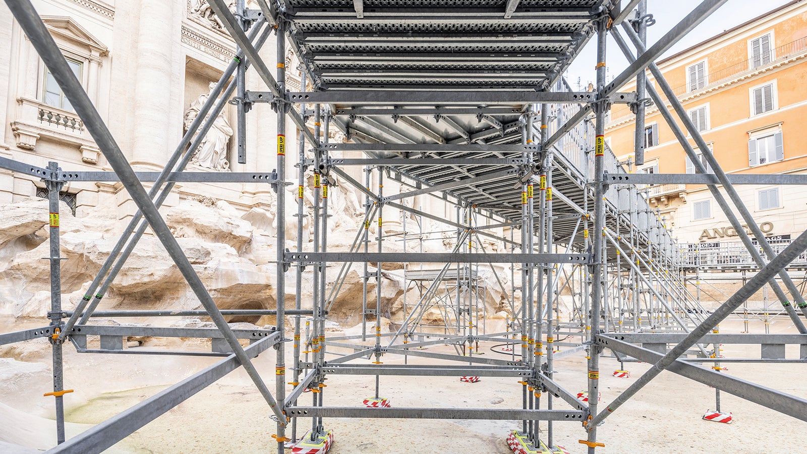 The scaffolding supports were placed on rubber pads and wooden boards to protect the vulnerable surface of the Trevi Fountain.