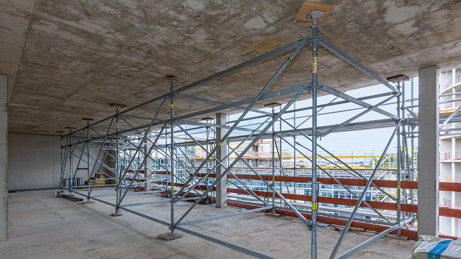 Innerhalb des obersten Bestandsstockwerkes waren PERI UP Stütztürme montiert, die mittels 25-cm-Riegeln und Diagonalen mit dem Fassadengerüst verbunden waren und so auskragend als Aufstellebene für die darüberliegenden Gerüstlagen dienten.