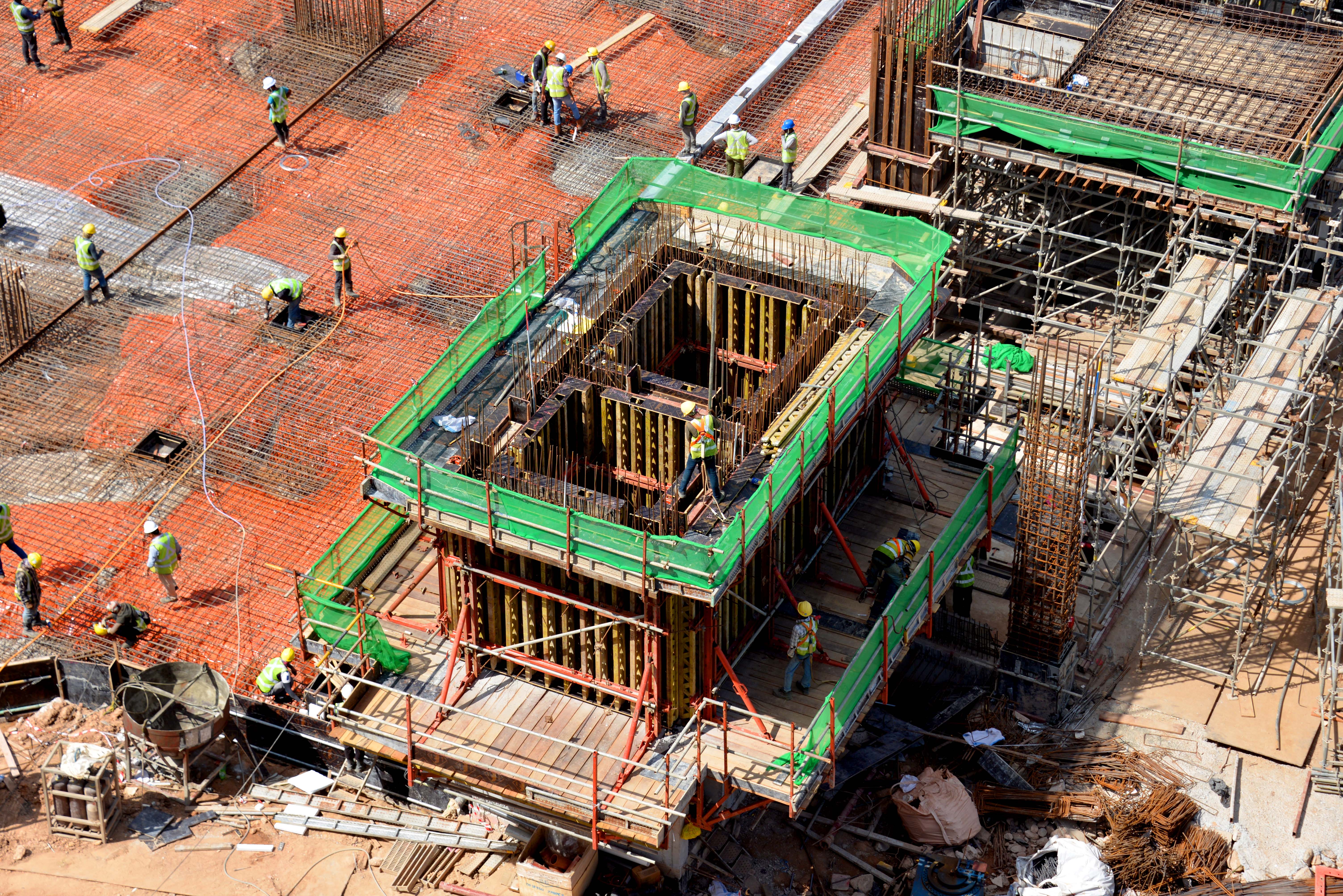 Site crew checking the connections after assembling CB 240 Climbing Formwork in preparation for casting