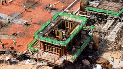 Site crew checking the connections after assembling CB 240 Climbing Formwork in preparation for casting