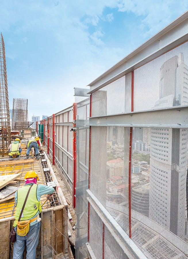 The perforated steel sheeting used as enclosure of the PERI RCS P climbing protection panel is particularly suitable for use in warmer regions. It is air-permeable and prevents heat accumulation inside the building.