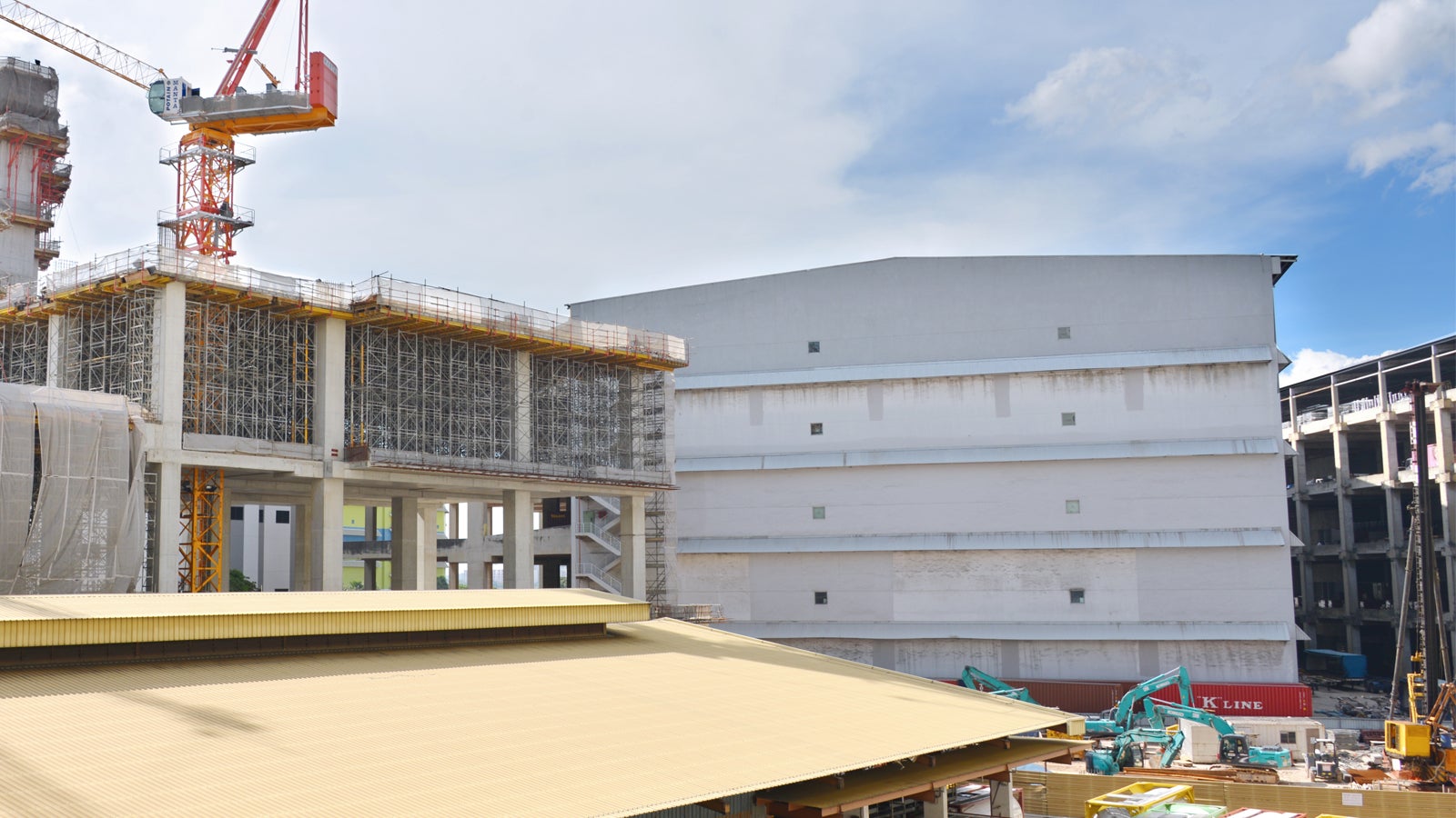 An overview of an old warehouse at the foreground that are waiting to be demolish in order to build a new warehouse by using PERI systems.