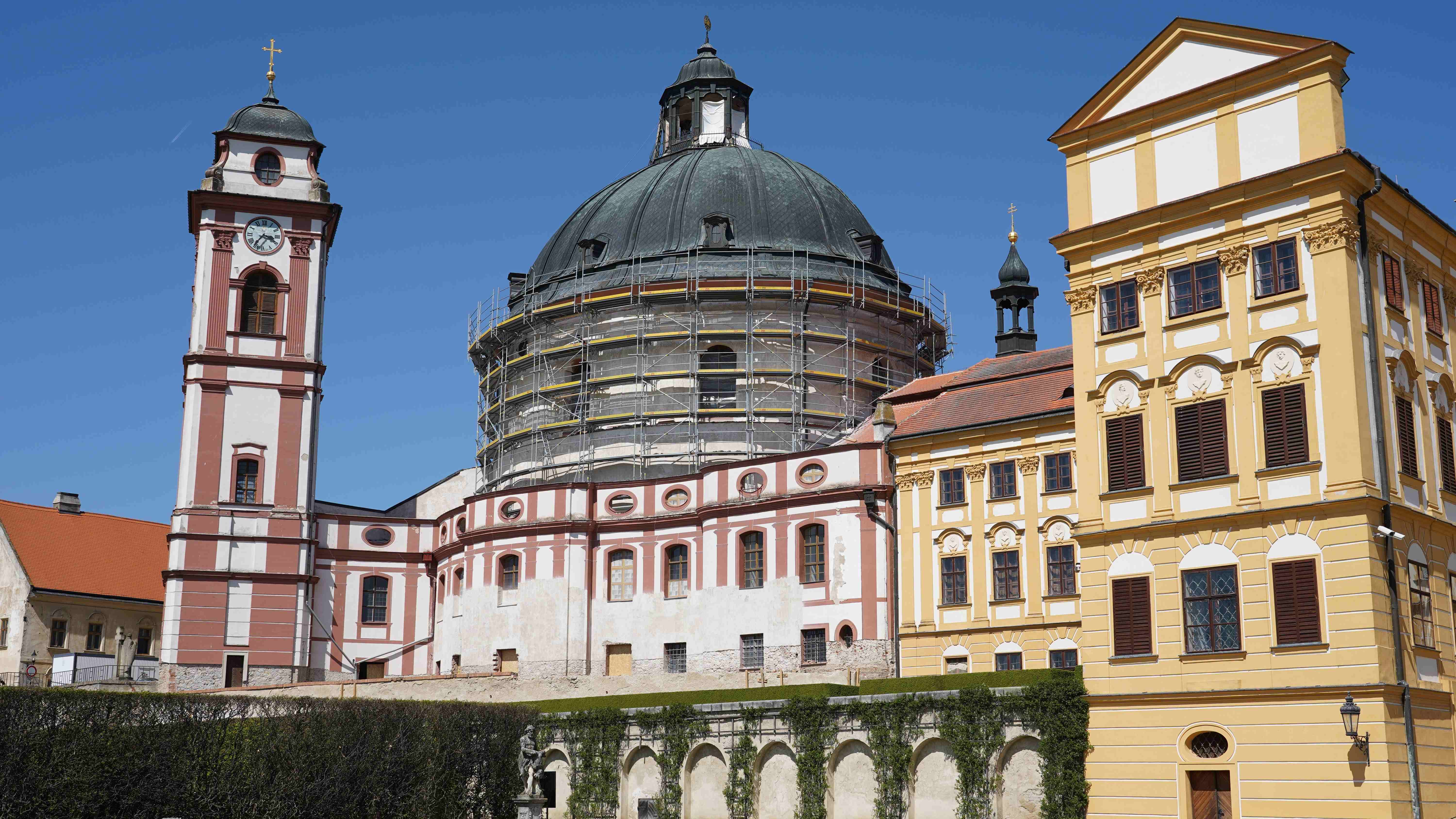 Vnější fasádní lešení na terasách okolo rondelu hlavní lodě se záchytnou sítí.