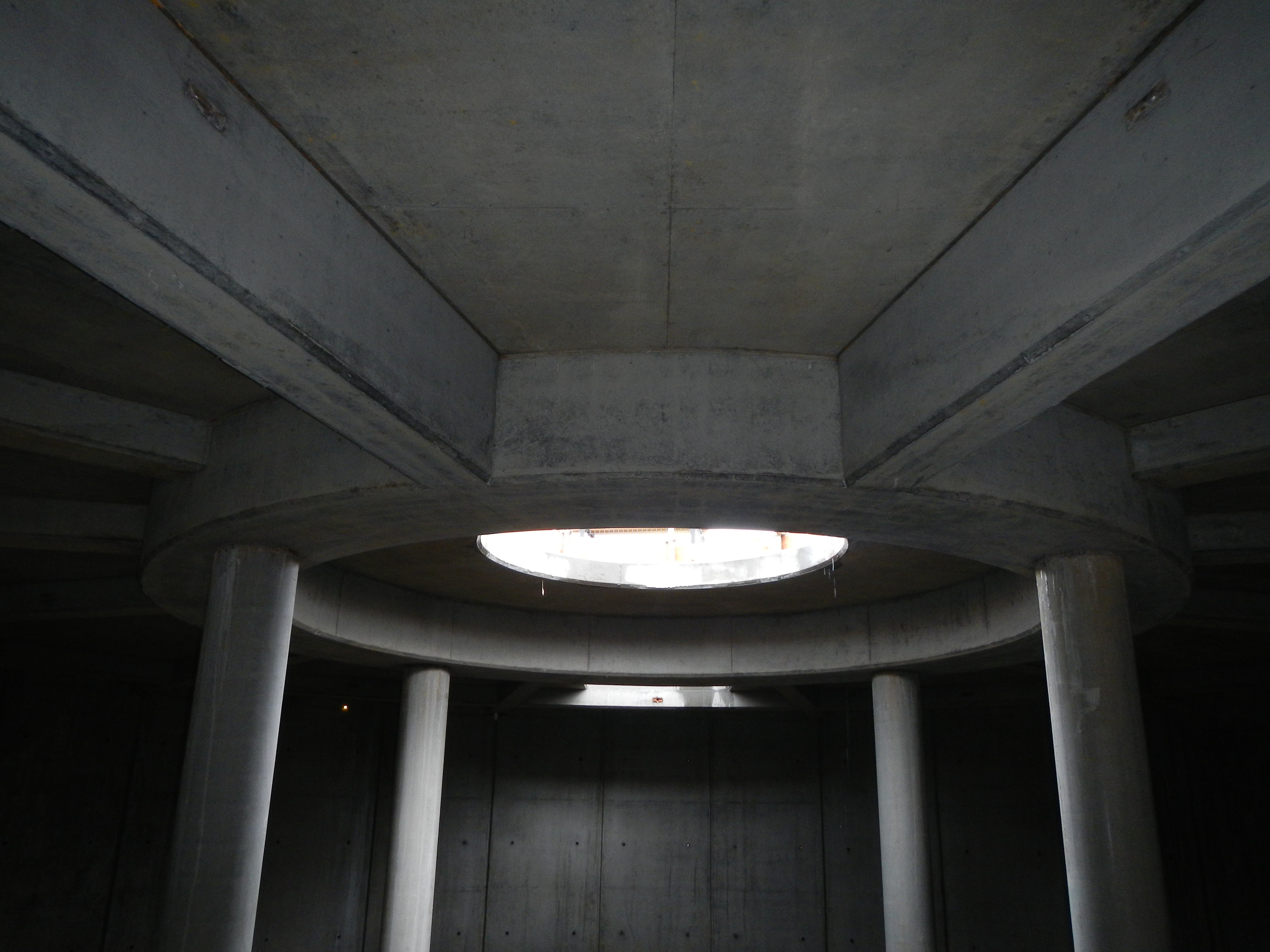 Architectural concrete finish is visible throughout the structure, both in circular and linear forms