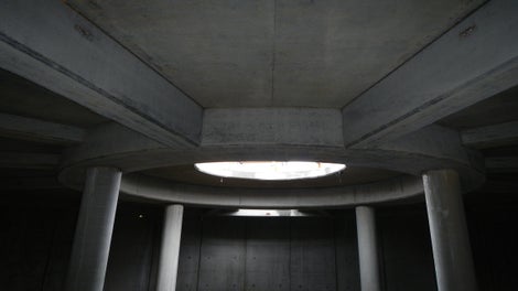 Architectural concrete finish is visible throughout the structure, both in circular and linear forms