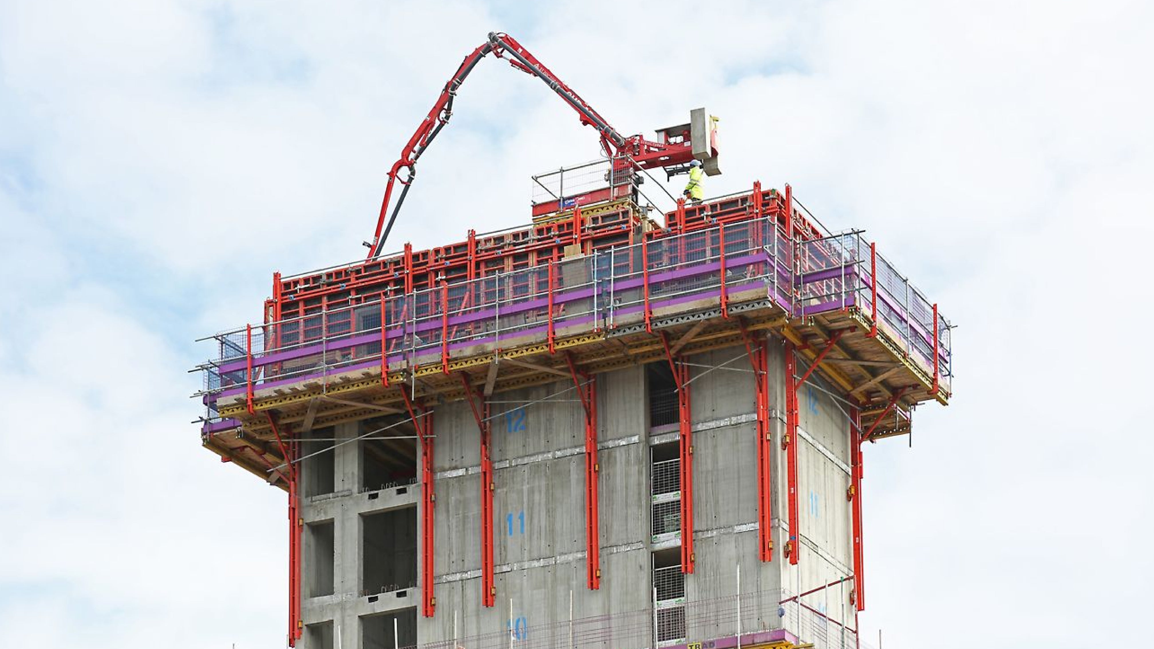 Bespoke Spider boom platform facilitates concrete placement on tower construction.