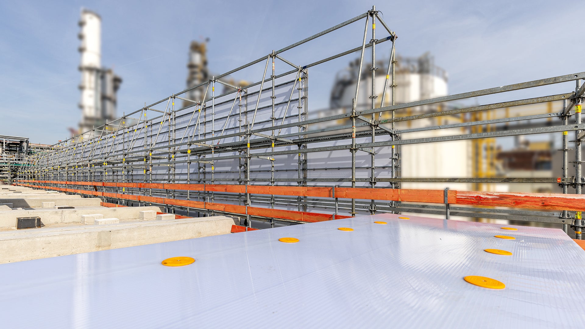 Für einen vorbeugenden Explosionsschutz während der Abdichtungsarbeiten am Sarkophagdach wurde nach Demontage des temporären Wetterschutzdaches das nördliche Gerüstauflager umgebaut und diente zusammen mit PERI UP Cladding als 65 m lange und 5 m hohe Schutzwand.