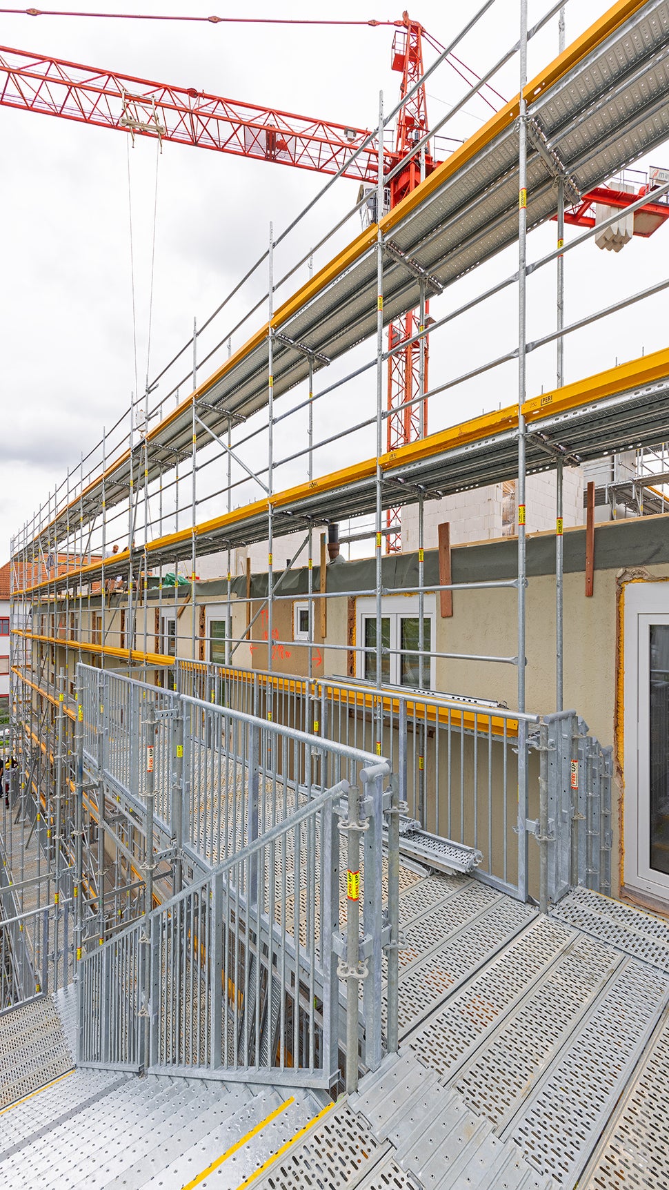 Während ein PERI UP Arbeits- und Schutzgerüst die Ausführung der Fassaden- und Aufstockungsarbeiten ermöglicht, sorgt die PERI UP Treppe Public dafür, dass alle 22 Wohnungen für die Bewohner und Passanten bequem und gefahrlos zugänglich sind.