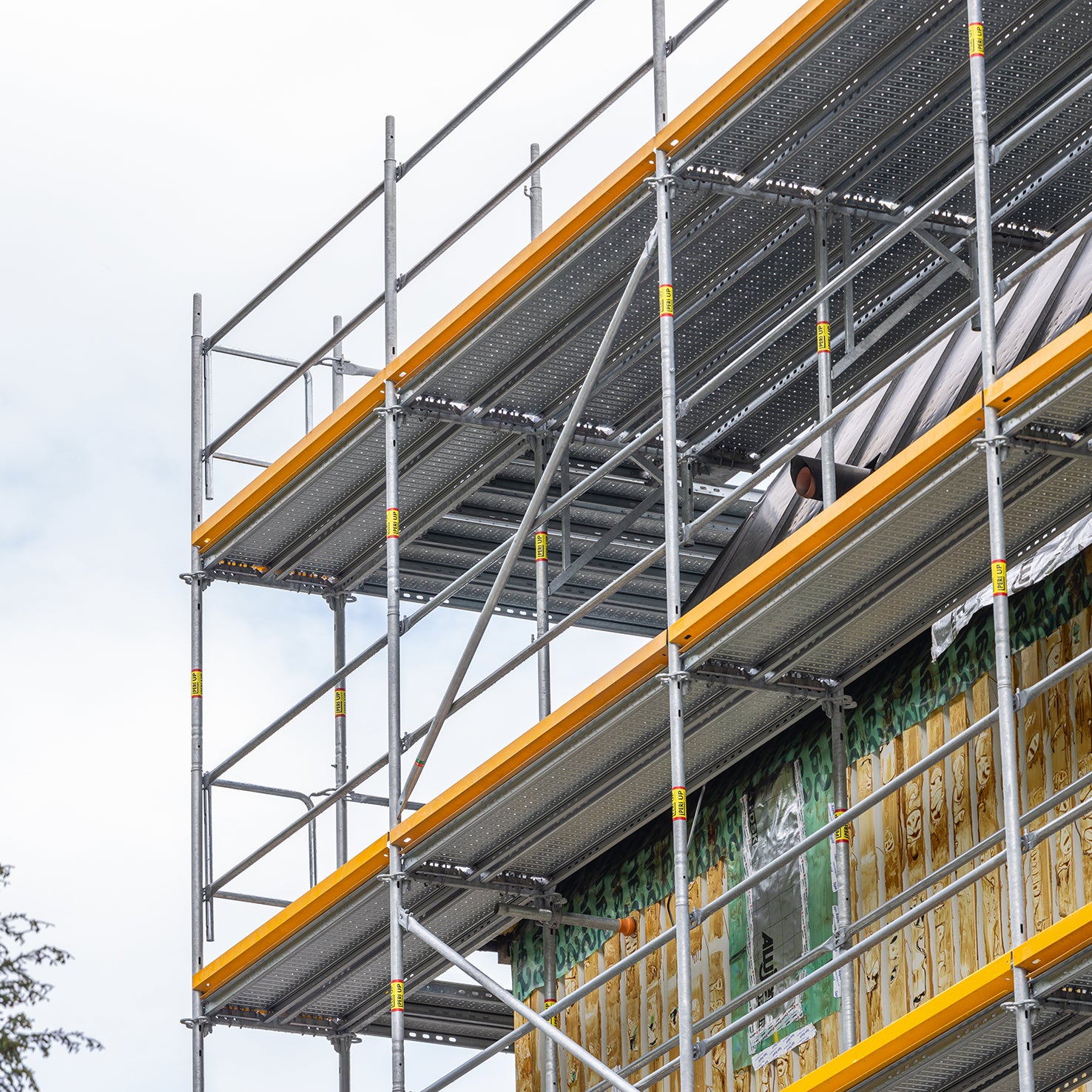 Die obersten Gerüstlagen, insbesondere deren Eckausbildungen, erlauben den sicheren und fachgerechten Rückbau der Kupferfassade und die anschließende Verlängerung des Ortgangs.