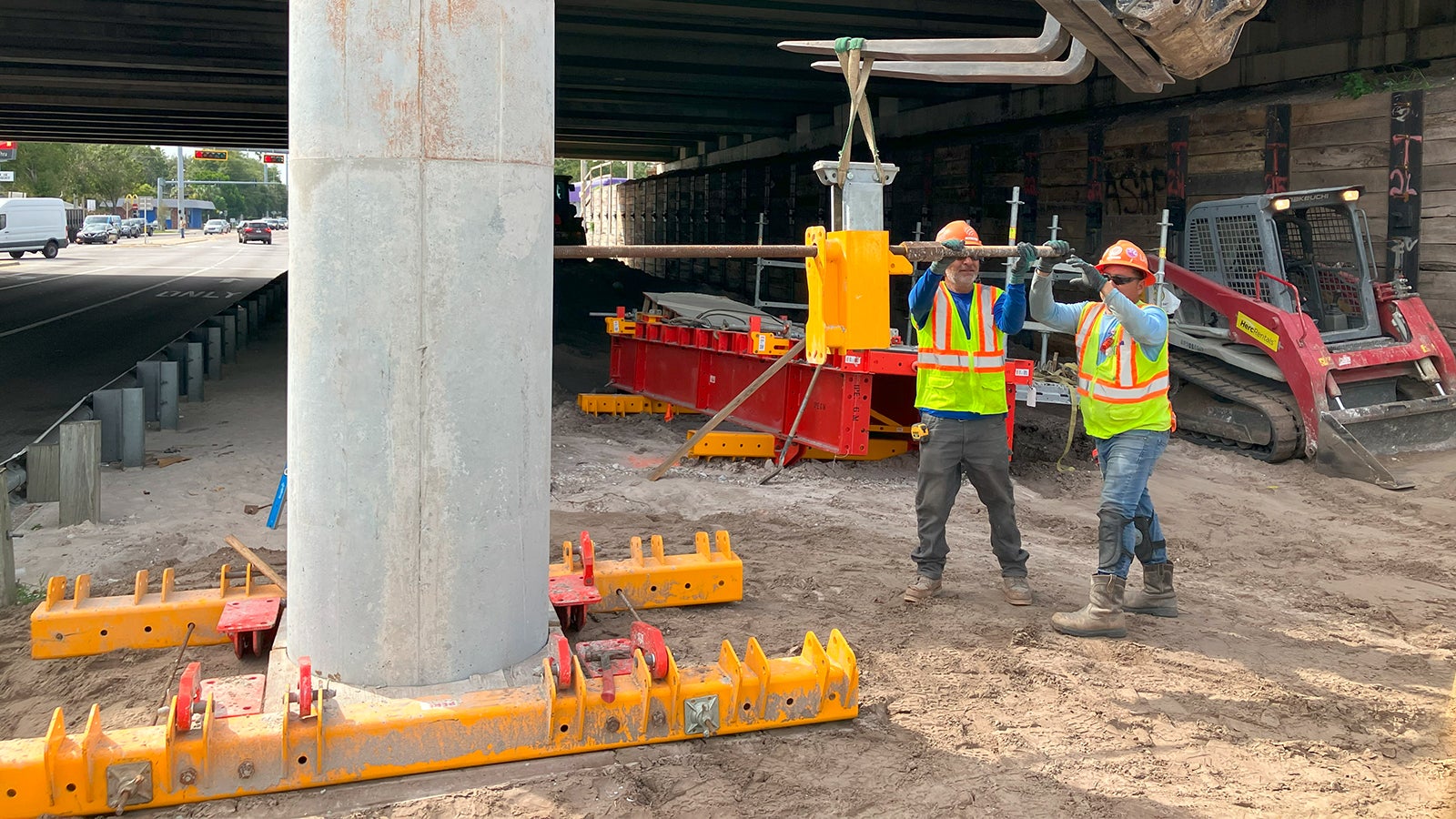 Crews install the column bracket which will support the work platform and new concrete loads of the hammerhead cap.