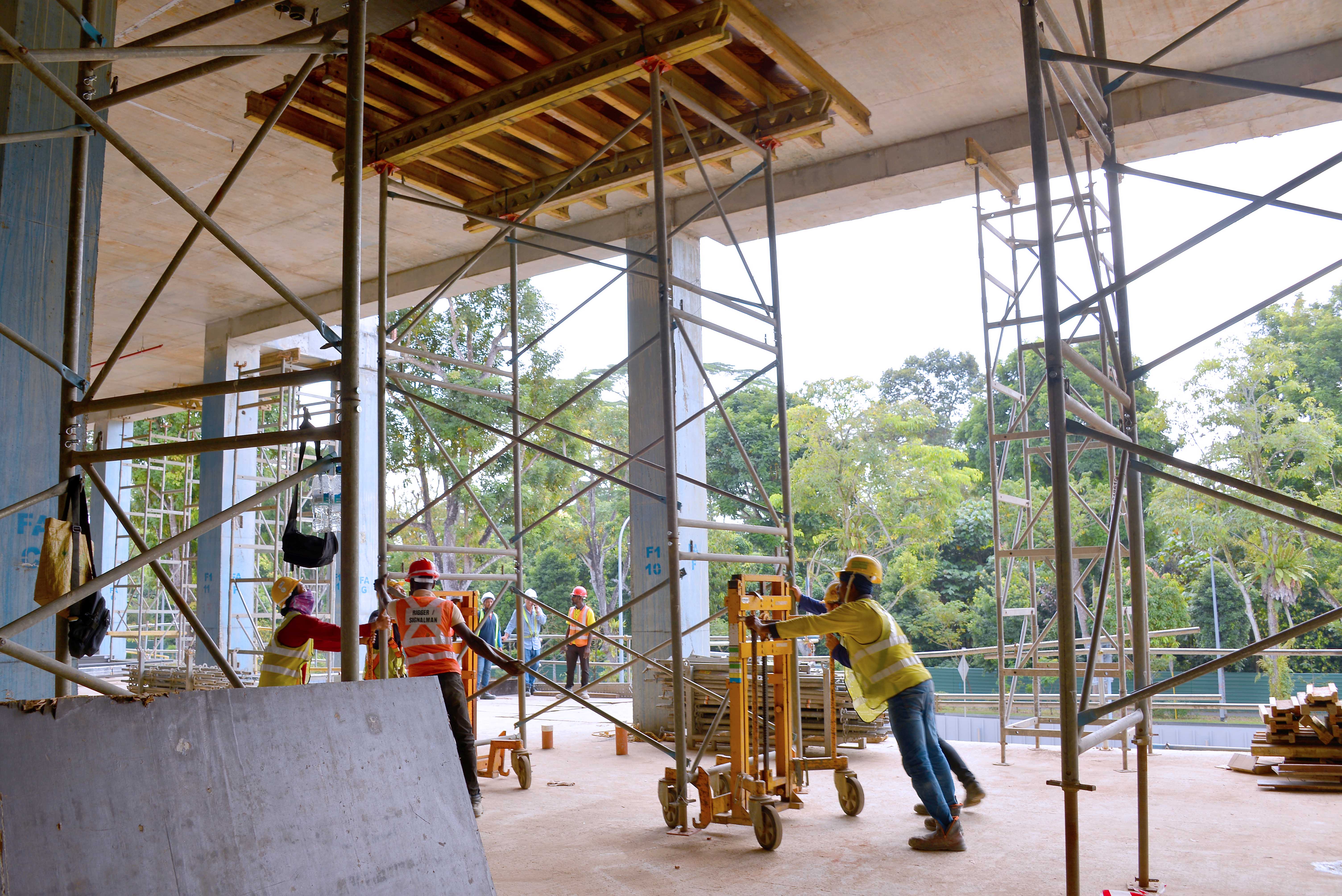Site crew transporting PD 8 Tableform easily with a trolley