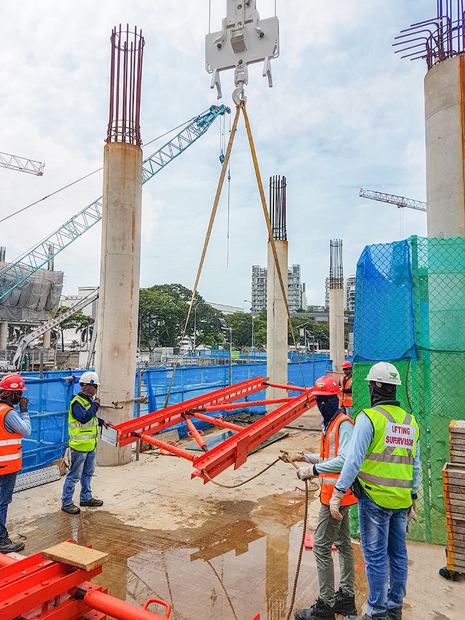 Part of the cantilevers are being lifted up by the crane.