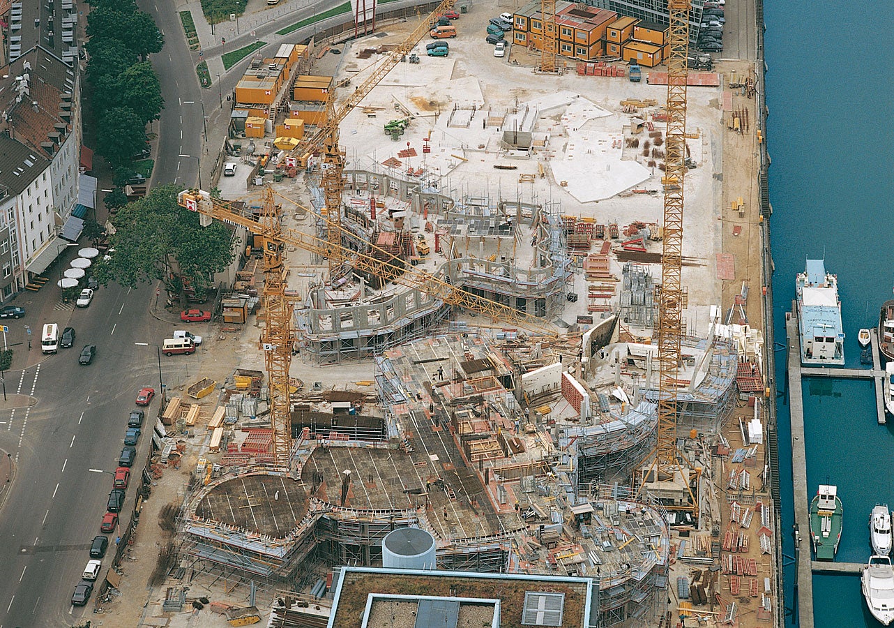 The three spectacular buildings of the new Zollhof complex in Dusseldorf during different stages of construction.