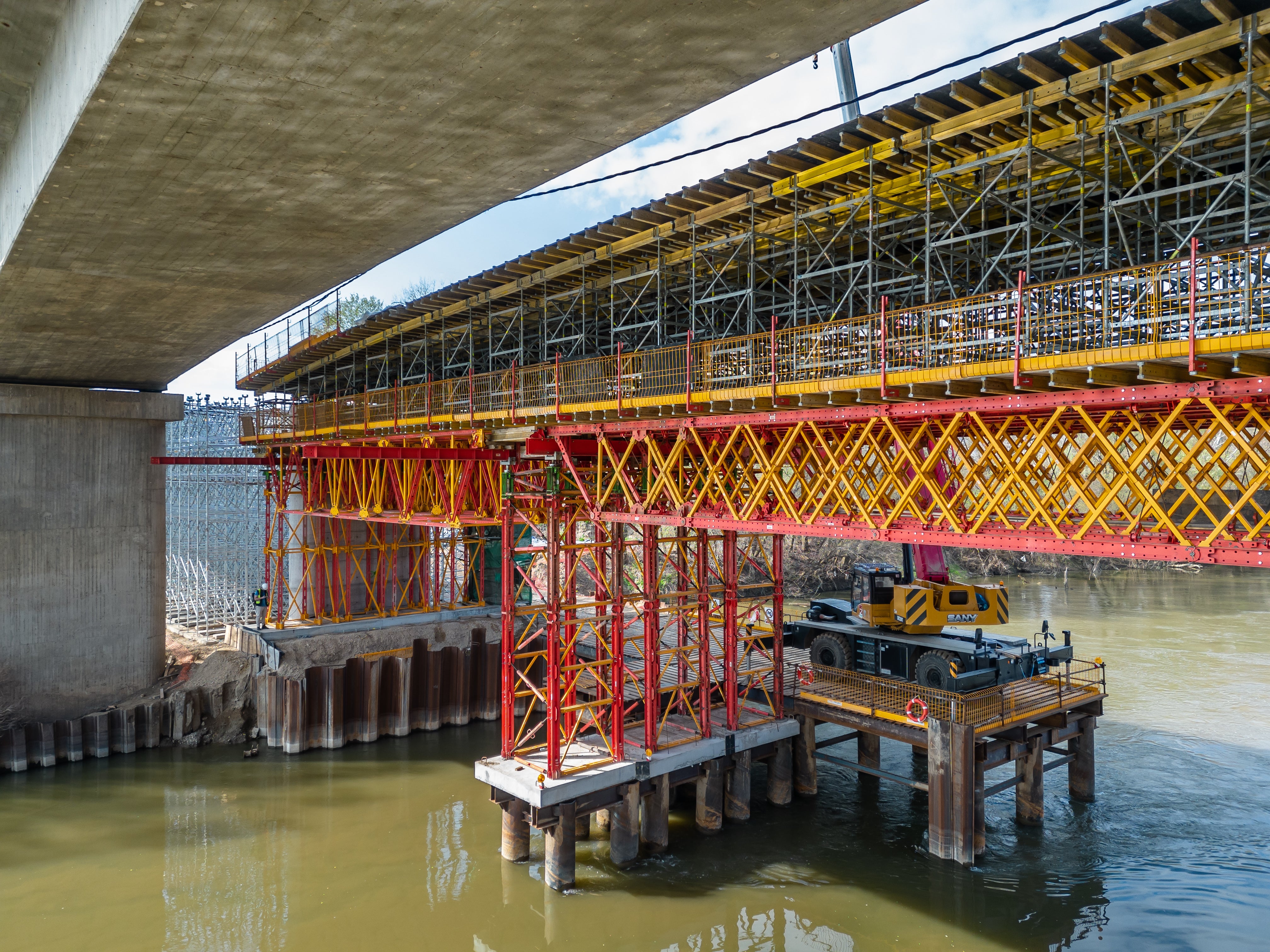 使用ALPHAKIT桁架梁为桥梁中间跨度的两端搭建长达16.25米的底部支撑结构。在接近S8、S9号桥墩位置处搭建ALPHAKIT塔架，并使用VST高强塔架系统在另一端头搭建塔架，支撑两侧的桁架梁结构。