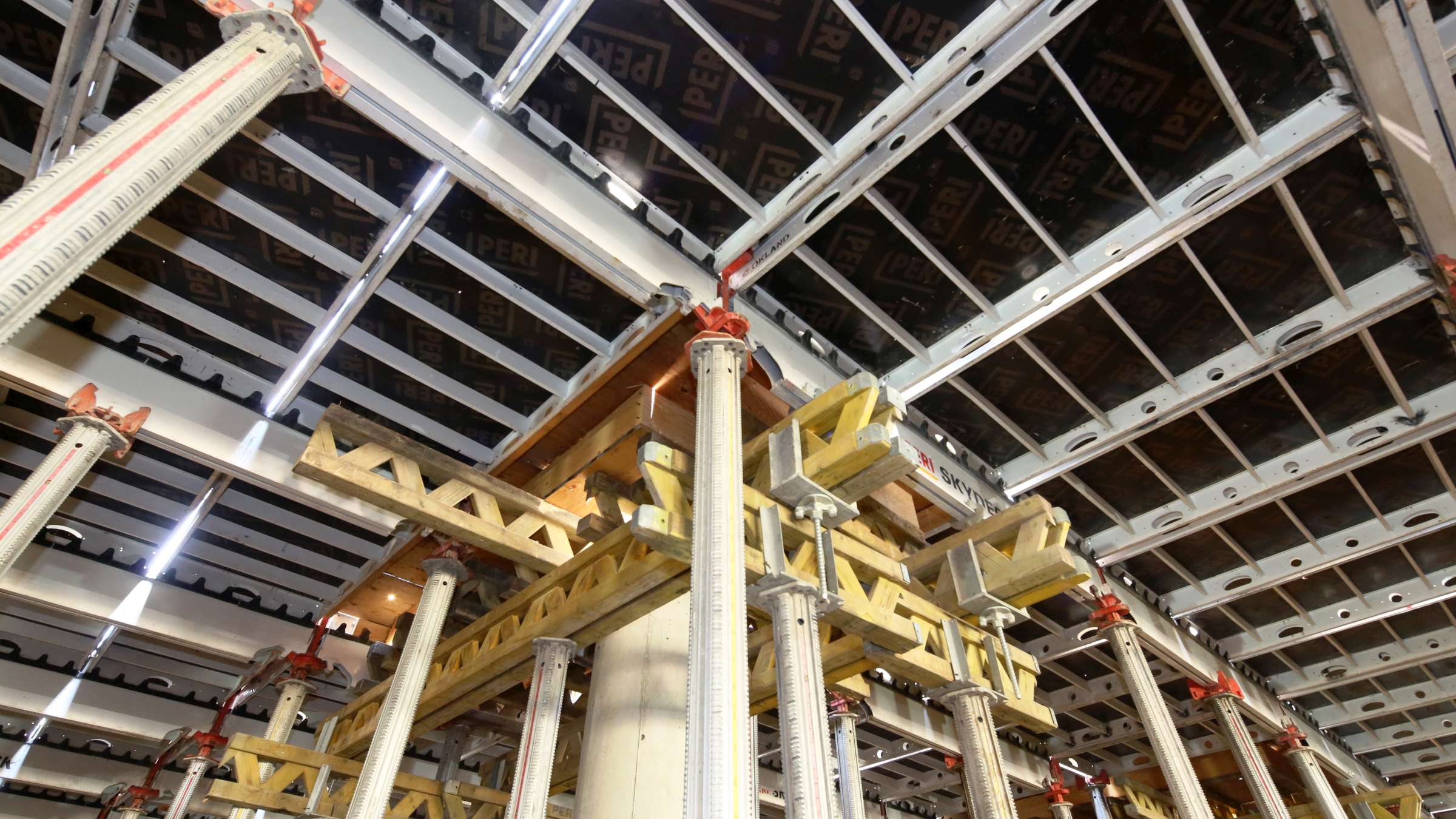 SKYDECK panels already have plywood integrated and SKYDECK beams have teeth that hold the panels in place after placing them on the beam.