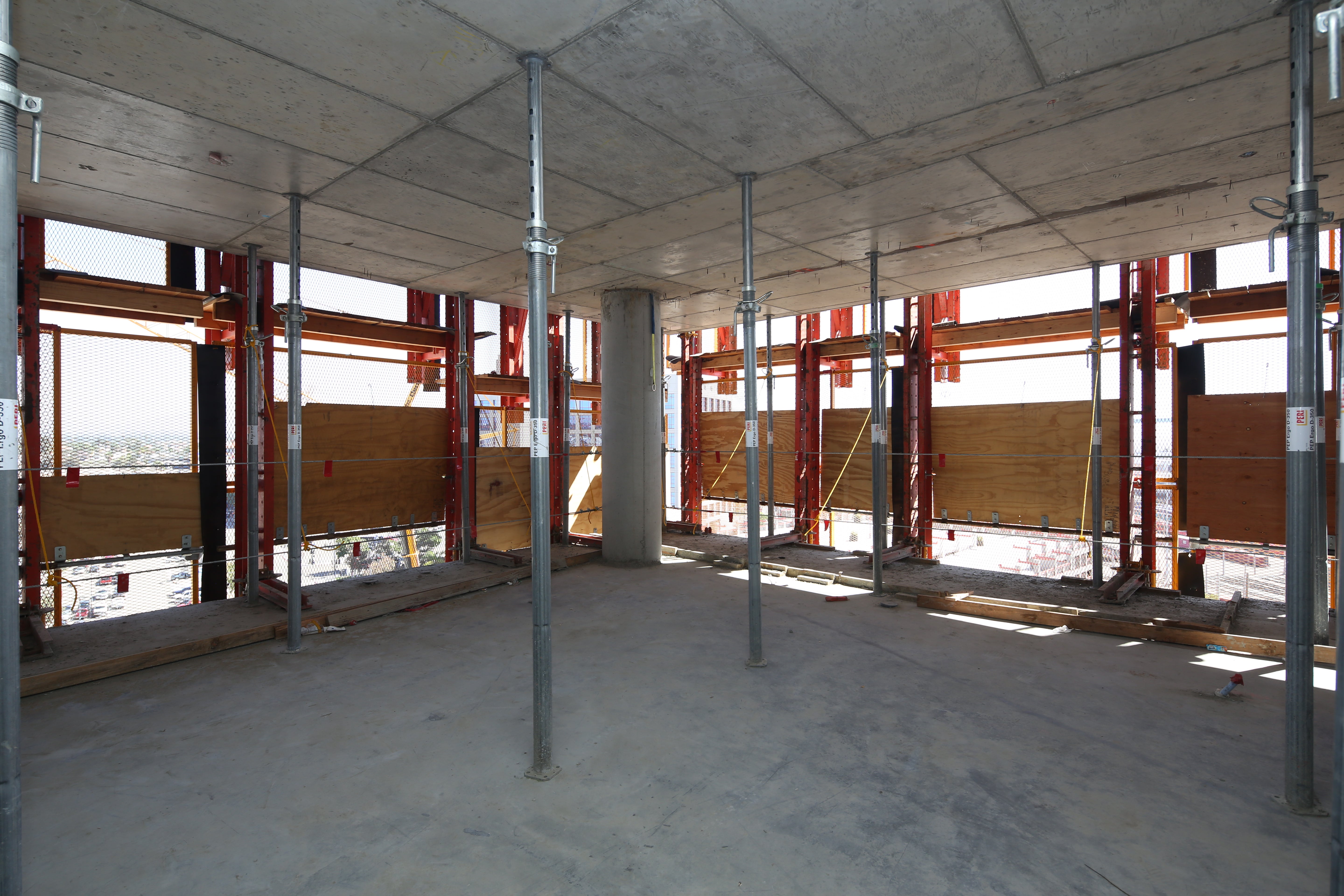 LPS Panels erected around the perimeter of the project shield crews and concrete from the wind while allowing light in.