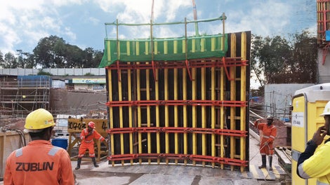 A section of the RCS Railing Climbing System is seen here on the GRV Articulated Waler Circular Formwork that are being lifted up by a crane to move inside the shaft.